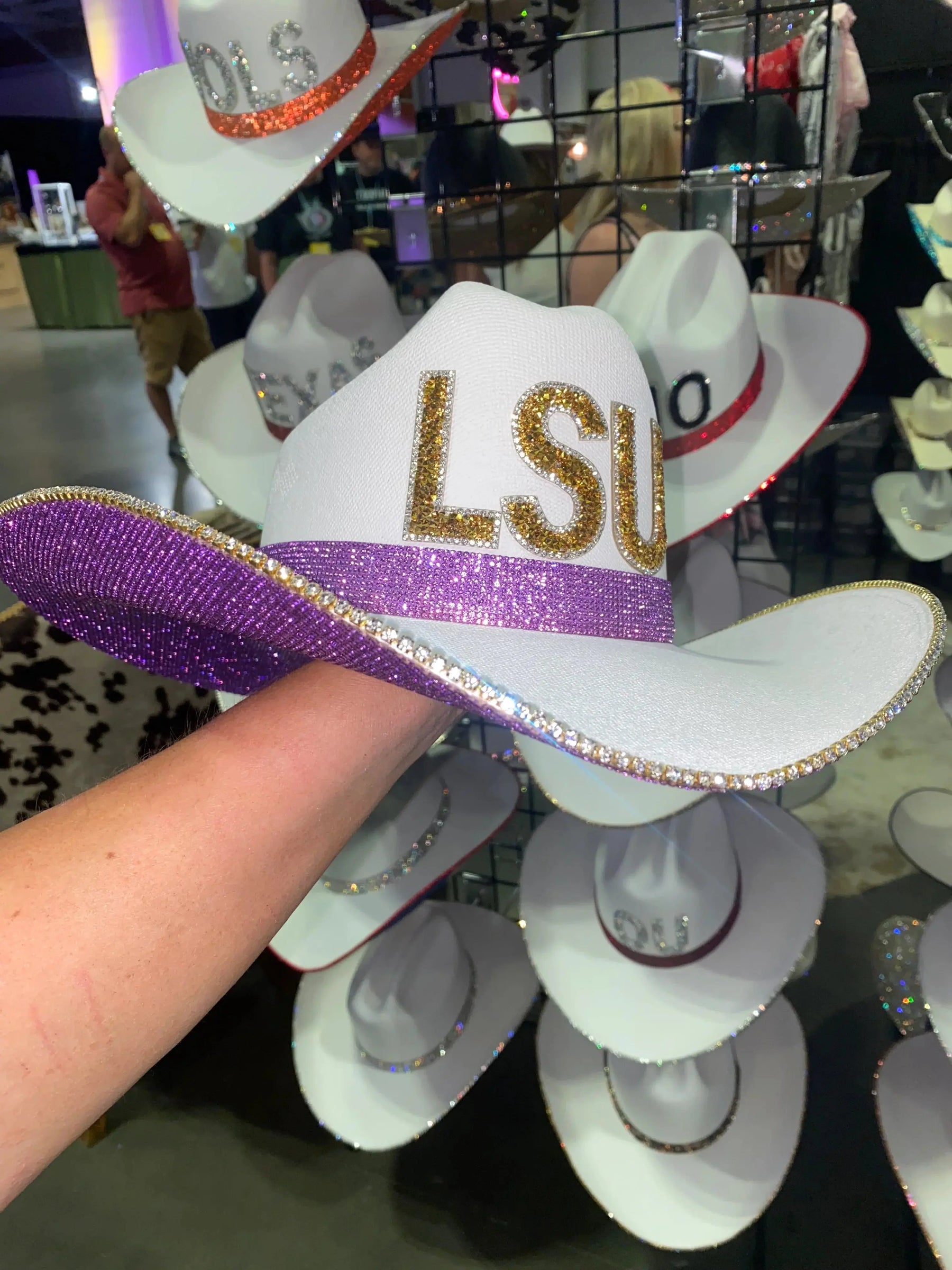 White cowgirl hat with purple brim and gold LSU letters