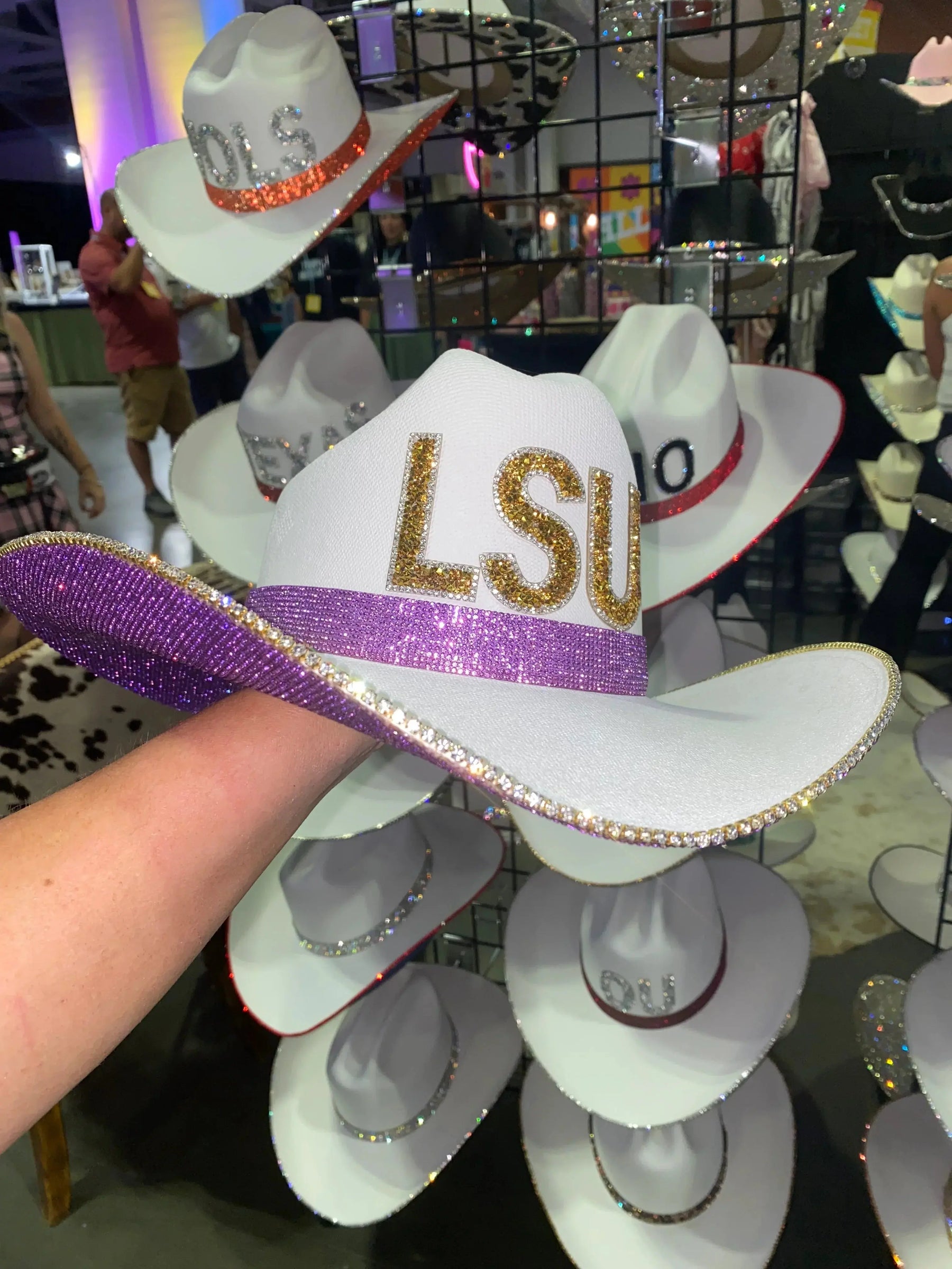 White cowboy hat with purple rhinestones and gold LSU letters