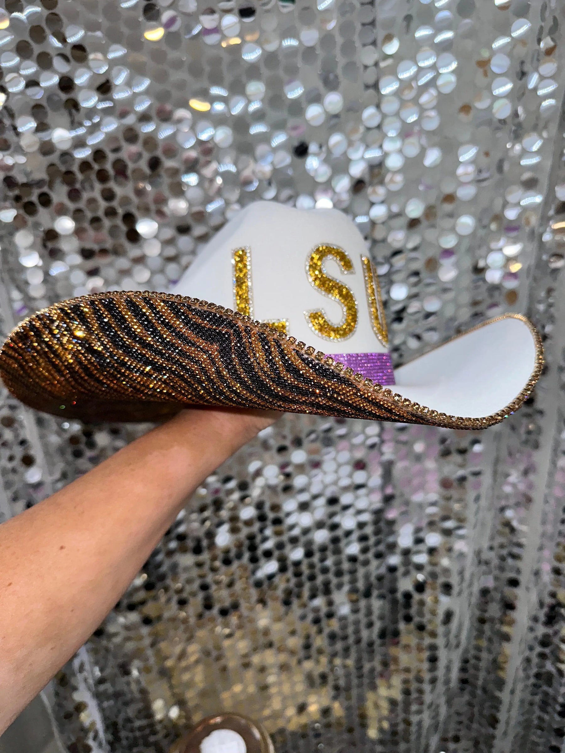 White LSU cowboy hat with tiger print brim and gold rhinestone letters