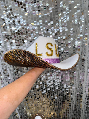White straw cowboy hat with gold LSU rhinestone letters and tiger print brim.