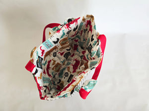 Handmade canvas tote bag with red straps, featuring farmhouse-themed animal and farm sign print interior fabric.