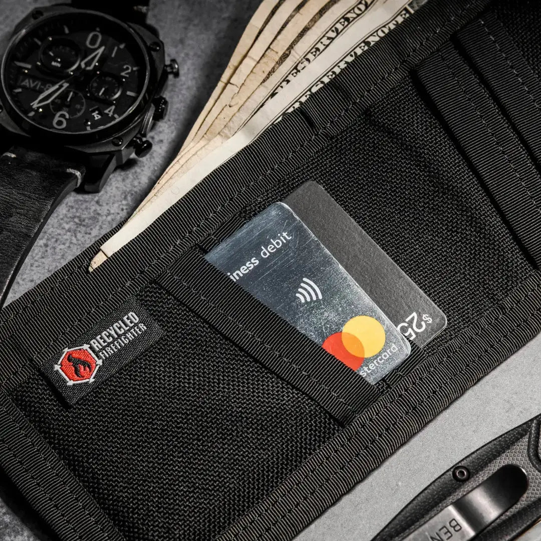 Black bifold wallet with credit cards, cash, and a watch.