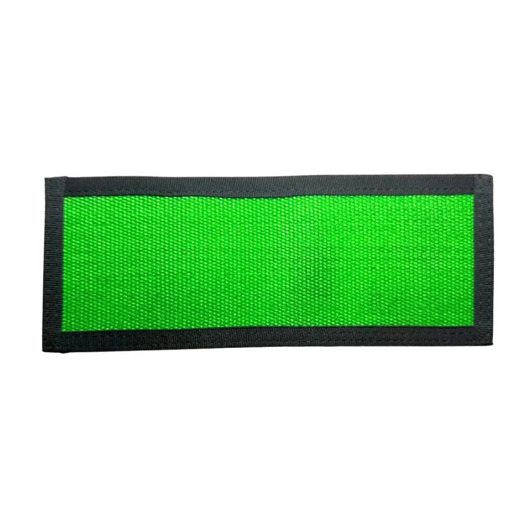 Green fabric patch with black border, made from fire hose material.