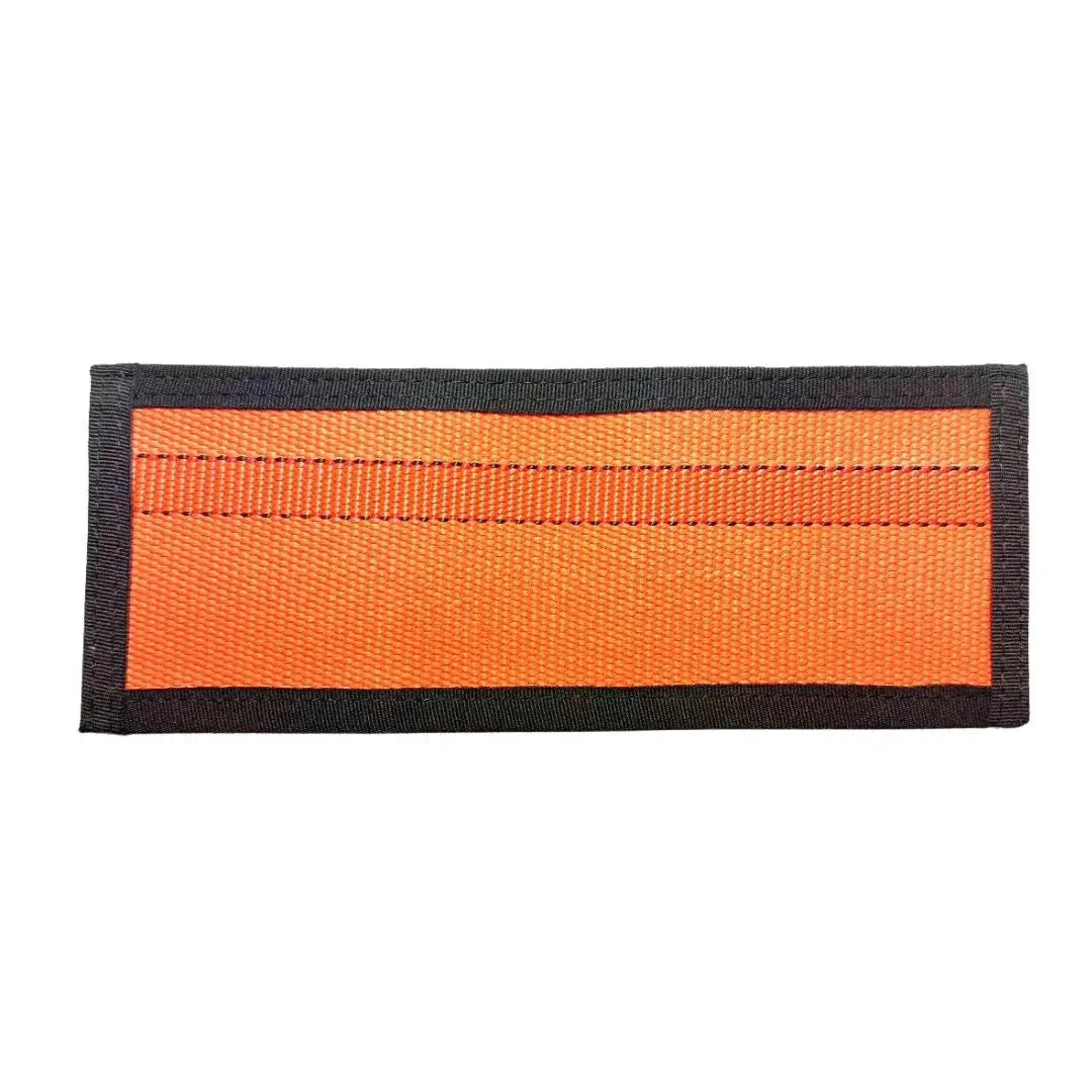 Orange rectangular fabric patch with black trim and visible stitching.