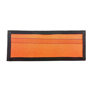 Orange rectangular fabric patch with black trim and visible stitching.