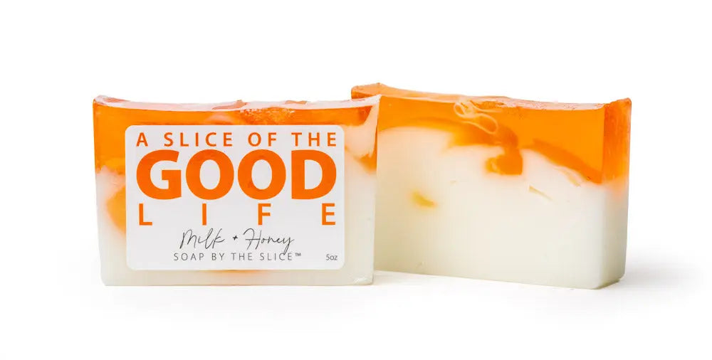 Two bars of milk and honey soap, one with a label, on a white background.