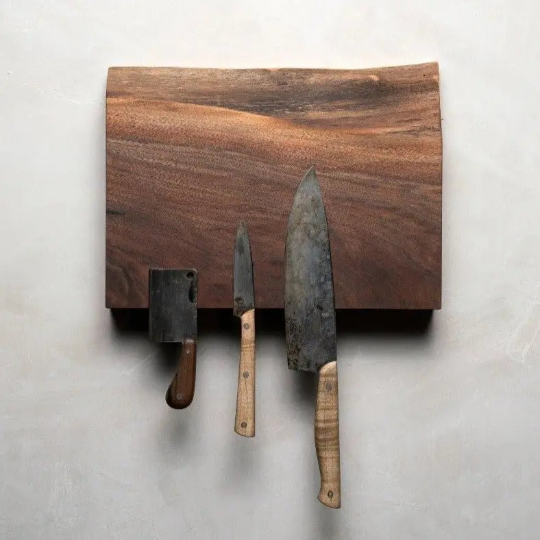 Magnetic wooden knife holder with three knives (cleaver, paring, chef) attached.