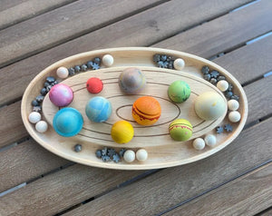 Maple sorting tray with colorful wooden planets and star pieces.