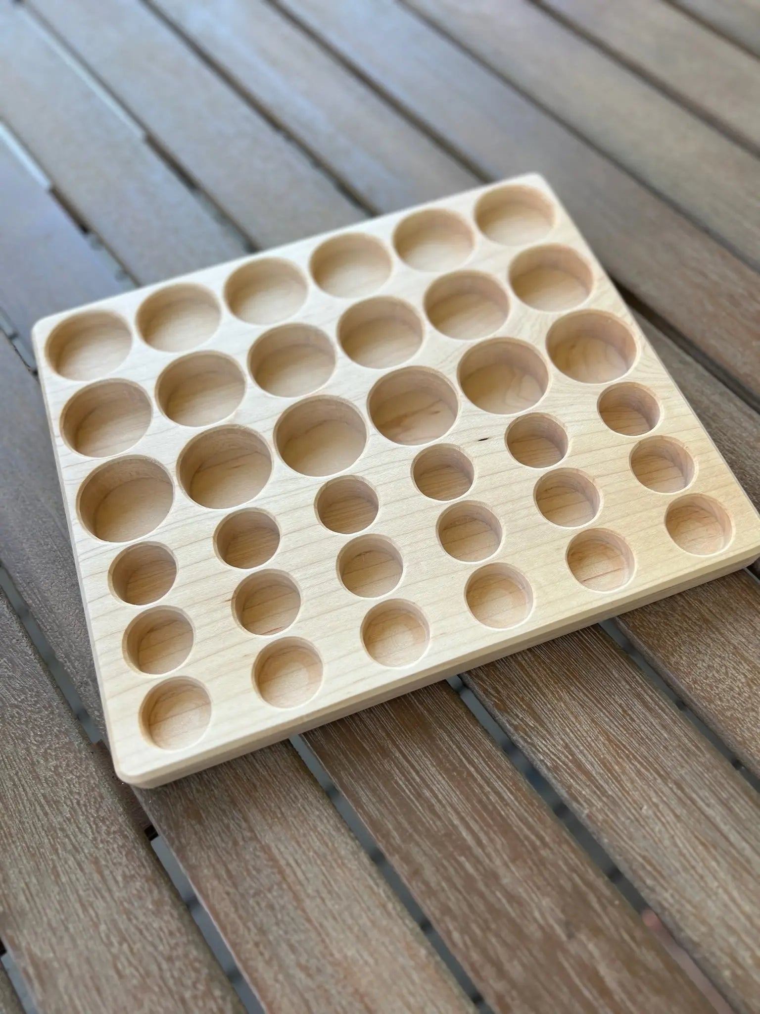 Maple sorting tray with circular indentations for Grapat Lola play