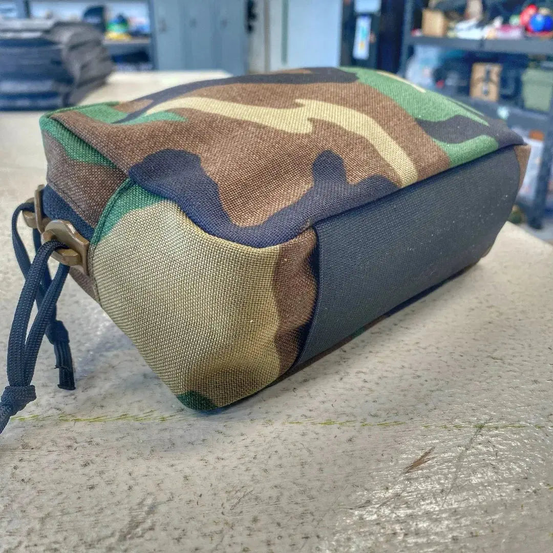 Woodland camouflage fanny pack made from Cordura nylon with black elastic band.
