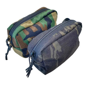 Two zippered fanny packs with woodland and dark camouflage patterns.