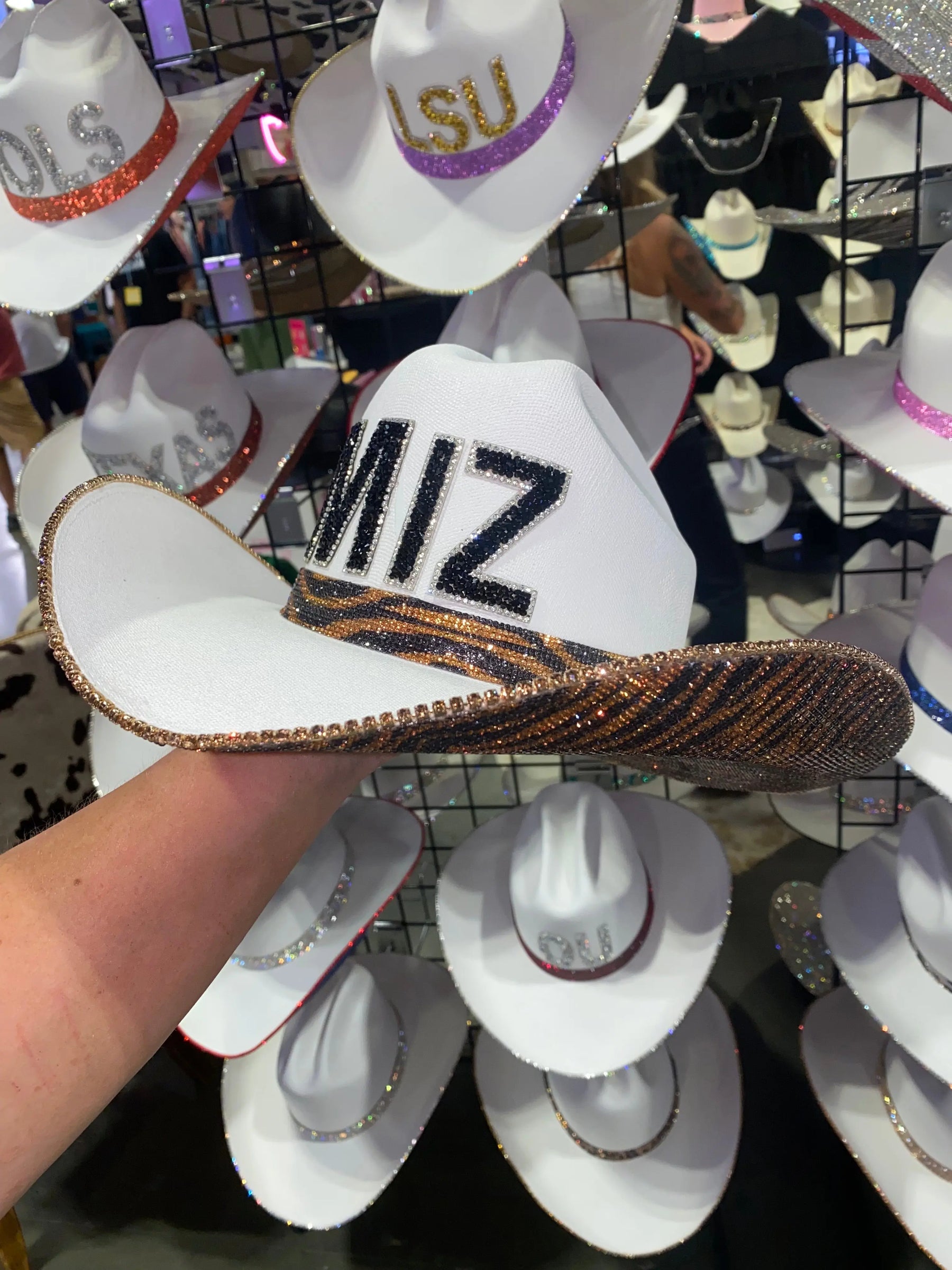 White Mizzou cowboy hat with black rhinestone letters and tiger print trim.