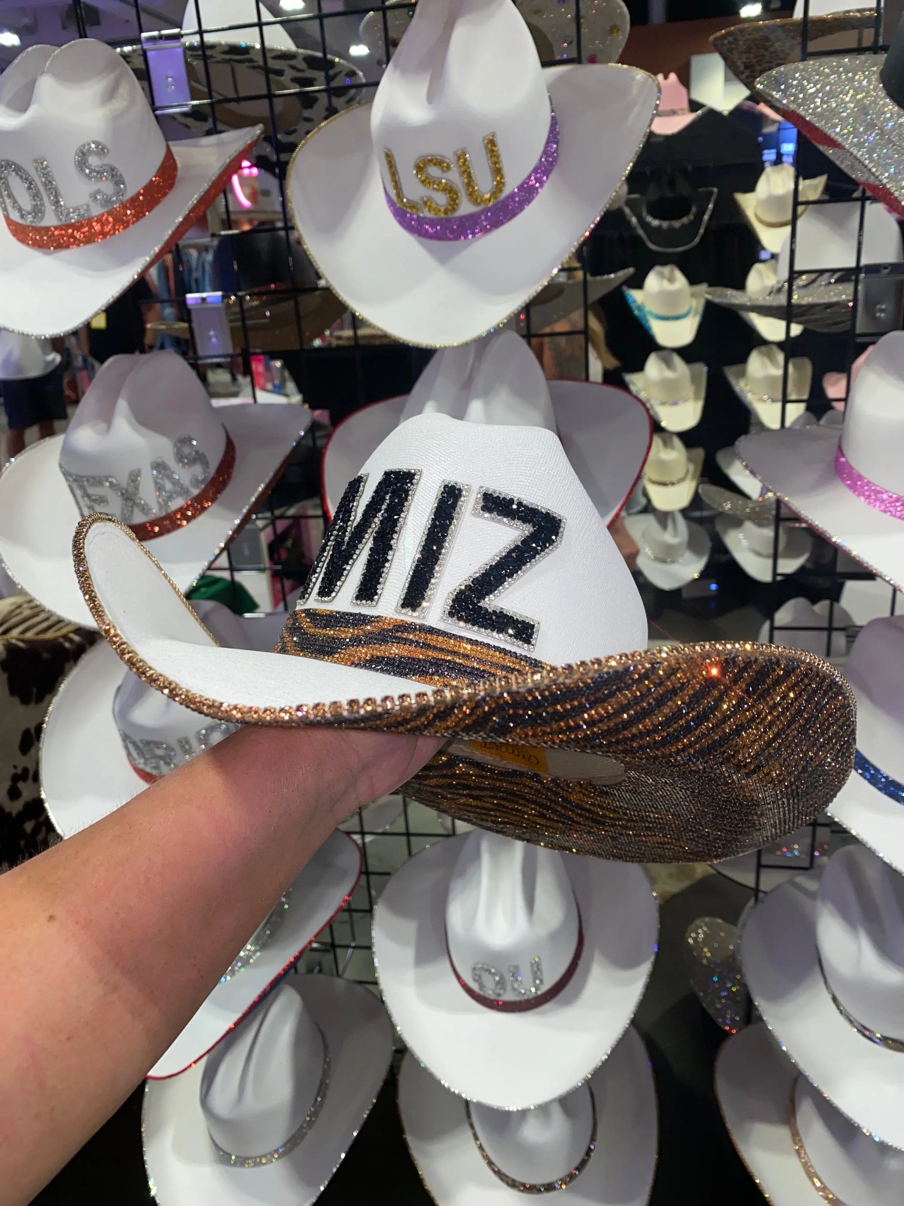 White Mizzou cowboy hat with black rhinestone letters and tiger stripe brim.