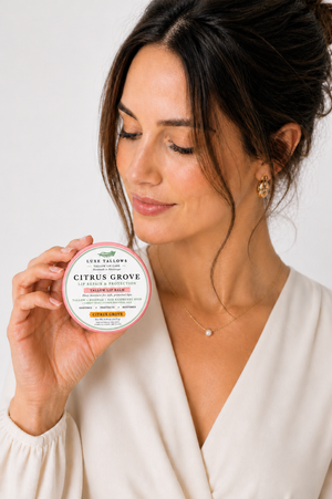 Model with citrus Grove lip repair tin