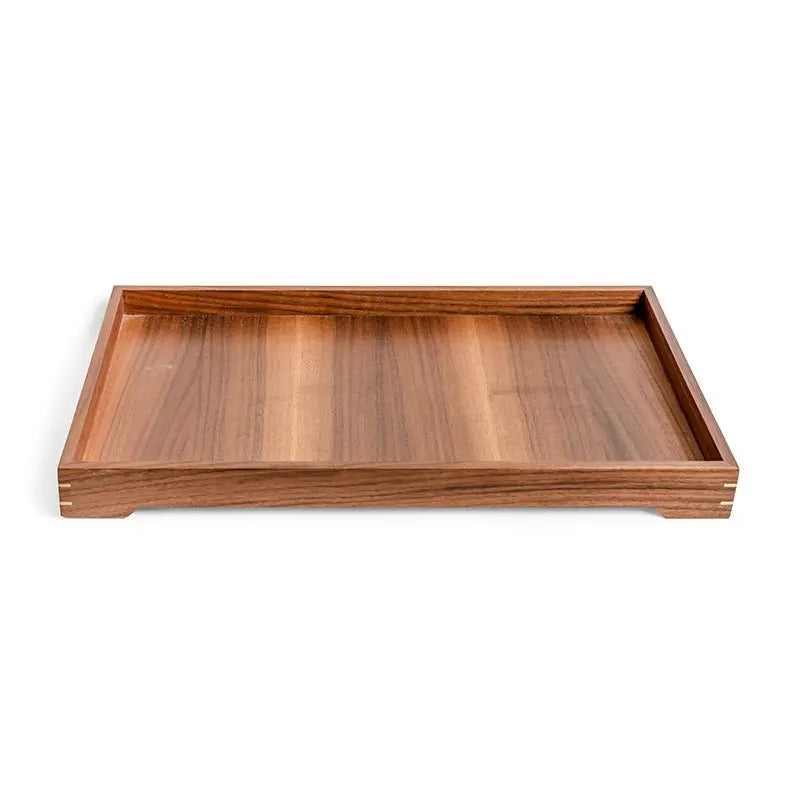 Rectangular wooden tray with raised edges and brass inlay detail on a white background.