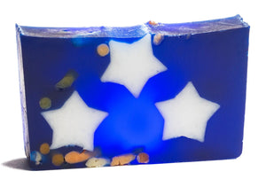 Blue soap slice with embedded white stars and colorful fragments, isolated on white.