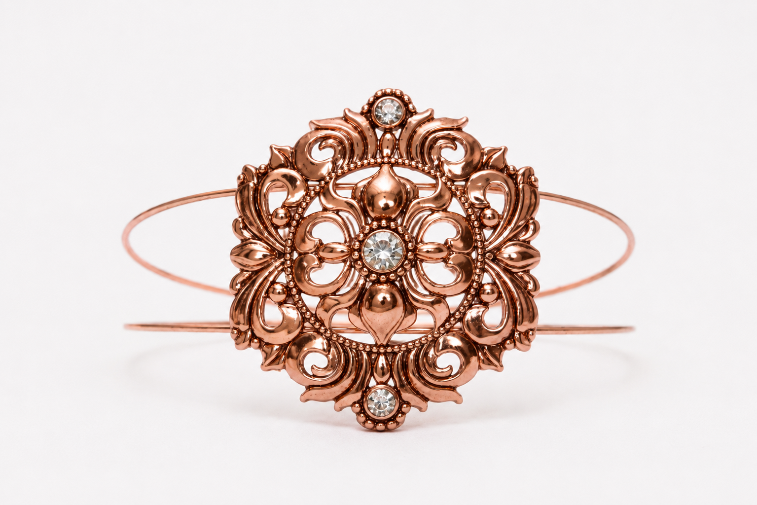 Copper tone rhinestone bracelet on white background