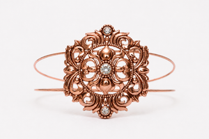 Copper tone rhinestone bracelet on white background