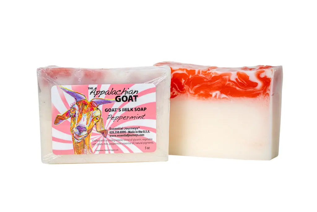 Two bars of peppermint goat milk soap, one with a label featuring a goat illustration.