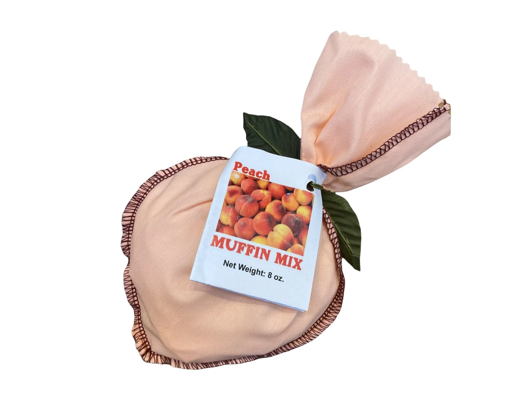Peach muffin mix in a fabric pouch with a label showing peaches.