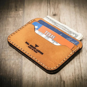 Tan leather card wallet with Texas ID and US dollars.