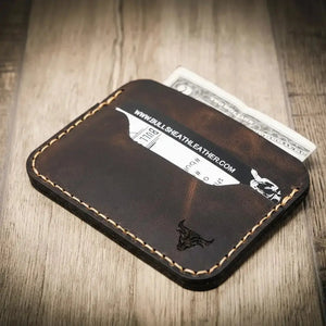 Brown leather cardholder with credit card and cash.