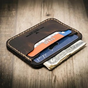 Dark brown leather card wallet with Texas ID and cash.
