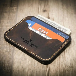 Brown leather card wallet with Texas ID and cash inserted, showing stitched details.