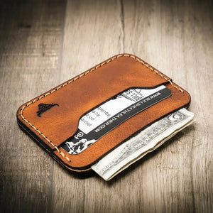 Brown leather card wallet with embossed bull logo, cash, and card from Bull Sheath Leather