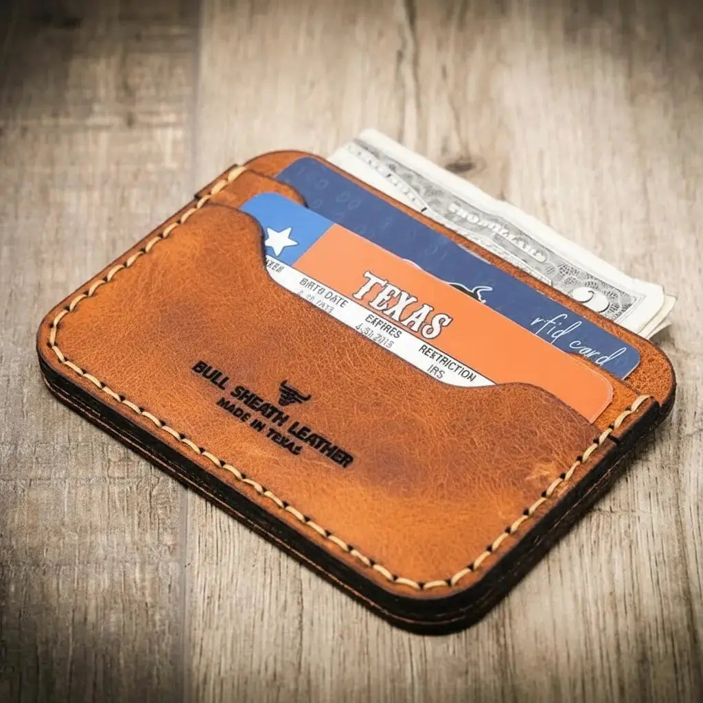Brown leather card holder with Texas ID and cash peeking out.