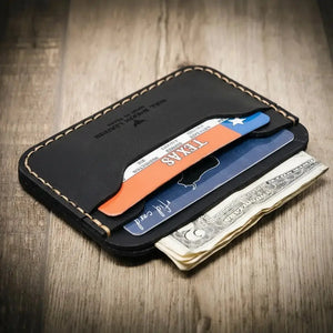 Black leather minimalist card wallet with Texas ID and cash.