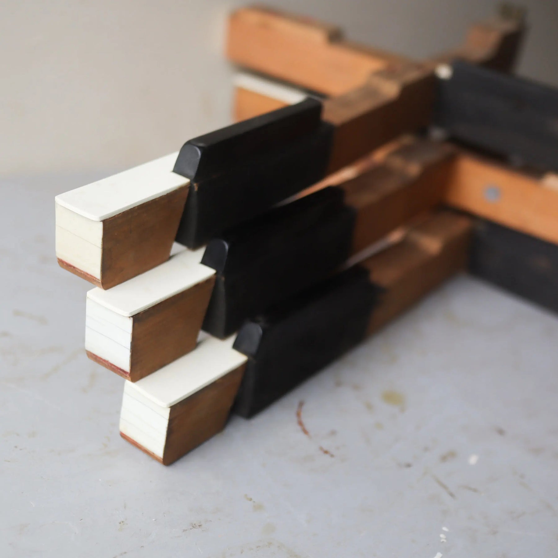 Handmade crosses made from reclaimed antique piano keys in white and black.