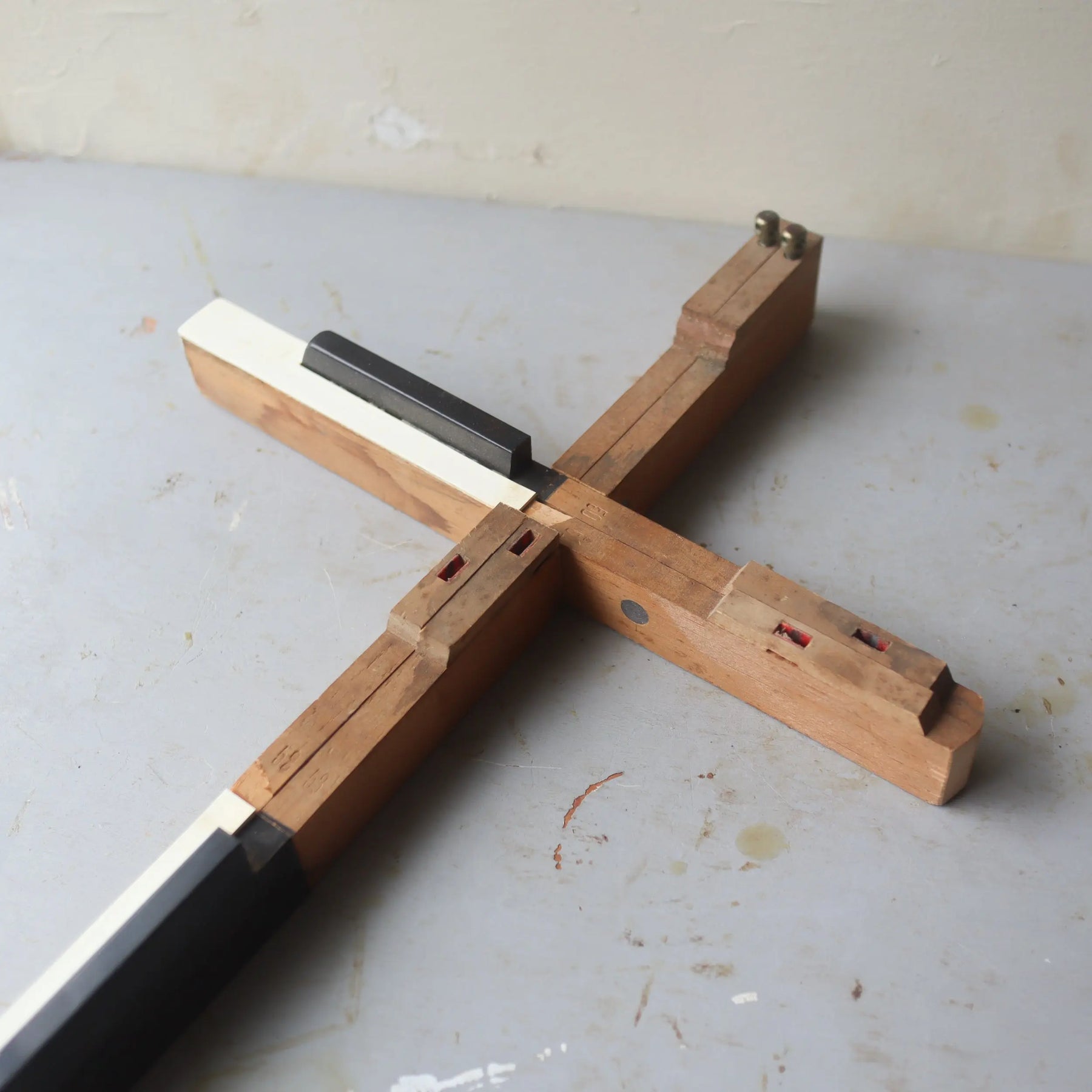 Wooden cross made from antique piano keys with a black insert.