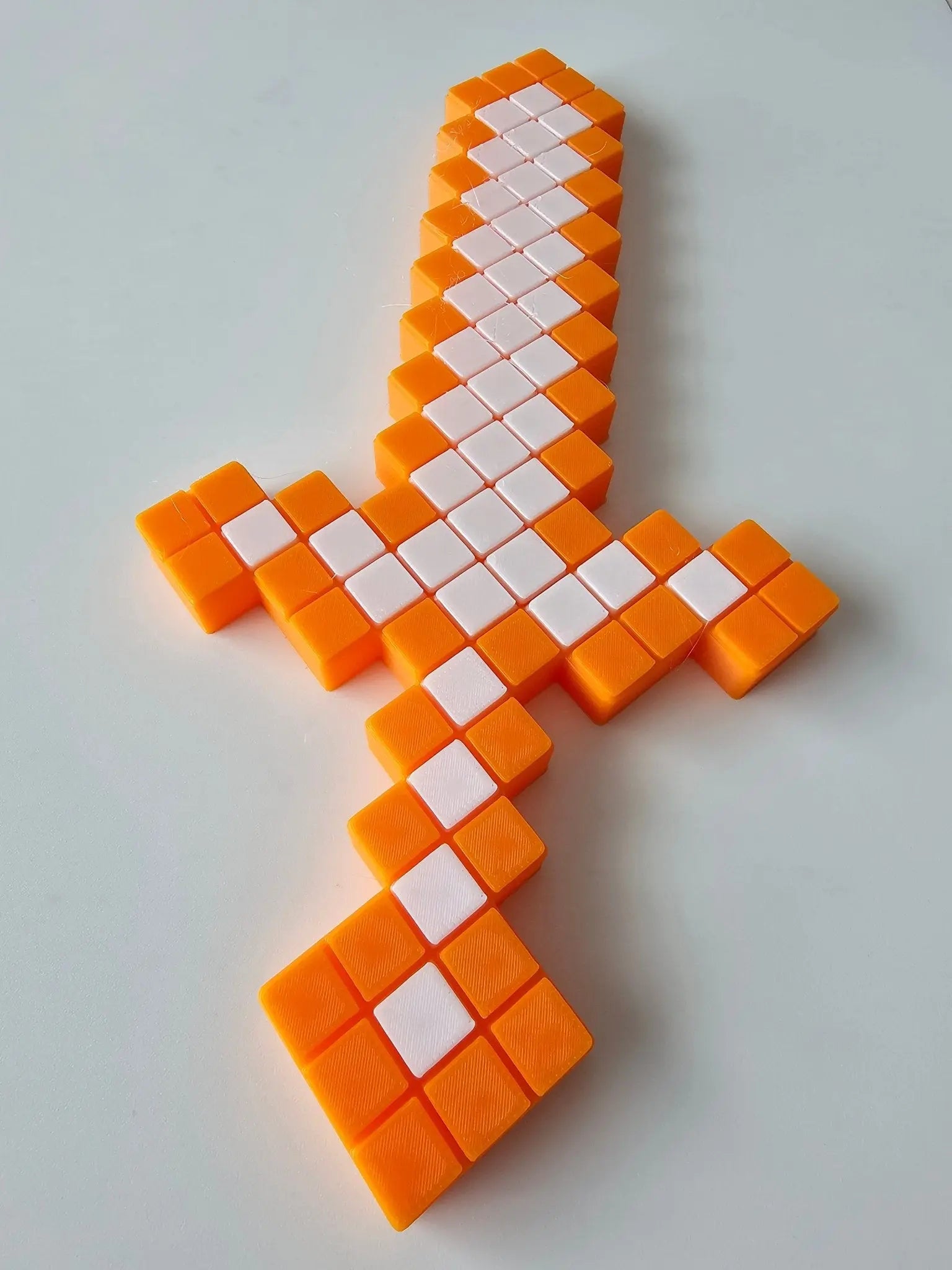 Minecraft-Inspired 3D Printed Pixel Sword - Orange & White Blocks, Toy Weapon for Imaginative Play, Cosplay, Room Decor.