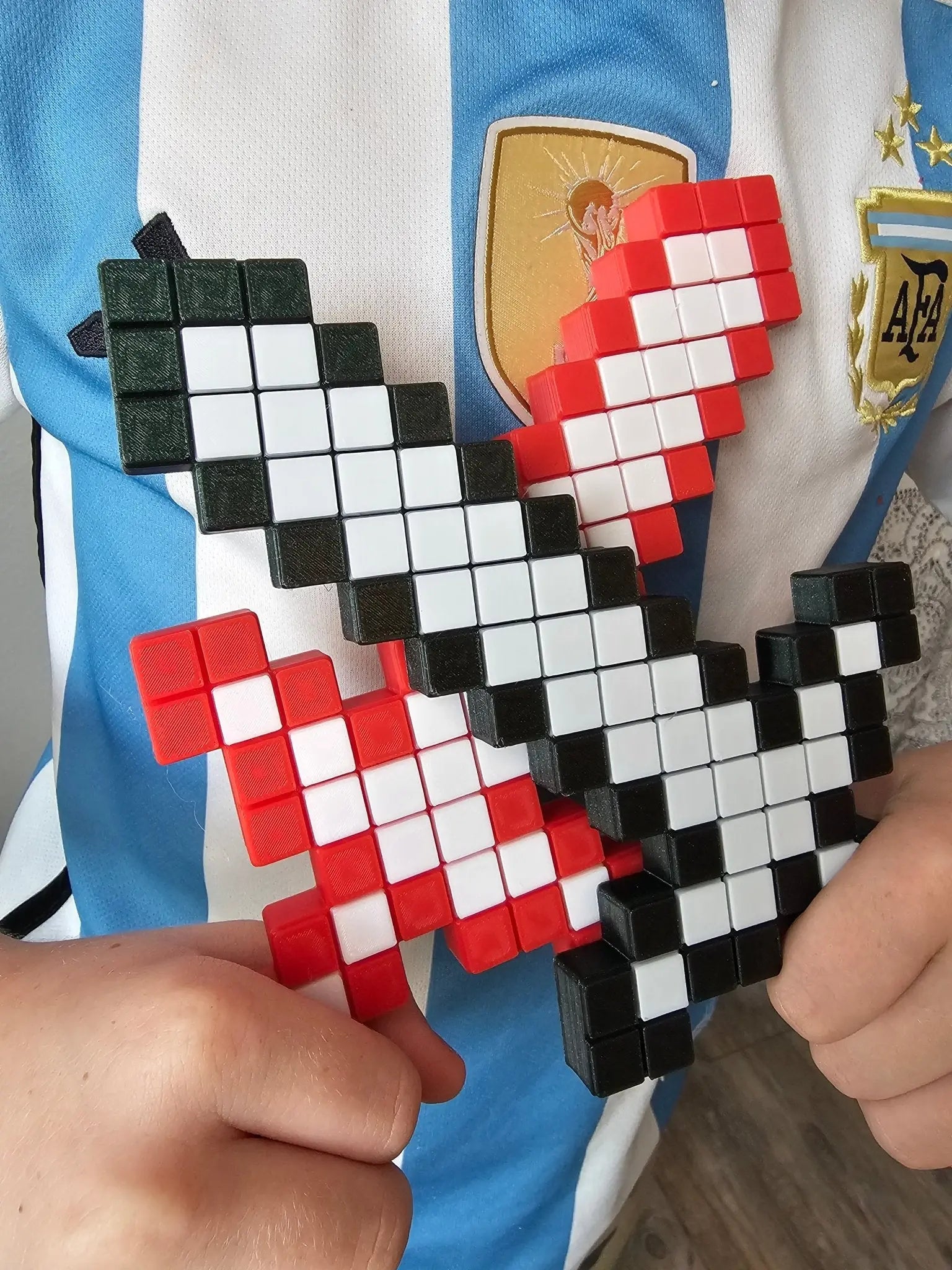 Pixel Sword: Red & Black 3D Printed Minecraft Toy Sword Held on an Argentina Soccer Jersey. Perfect Gift for Gamers & Collectors!