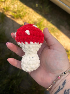 Crocheted red & white mushroom plush toy by Main Street Collective, held in hand.