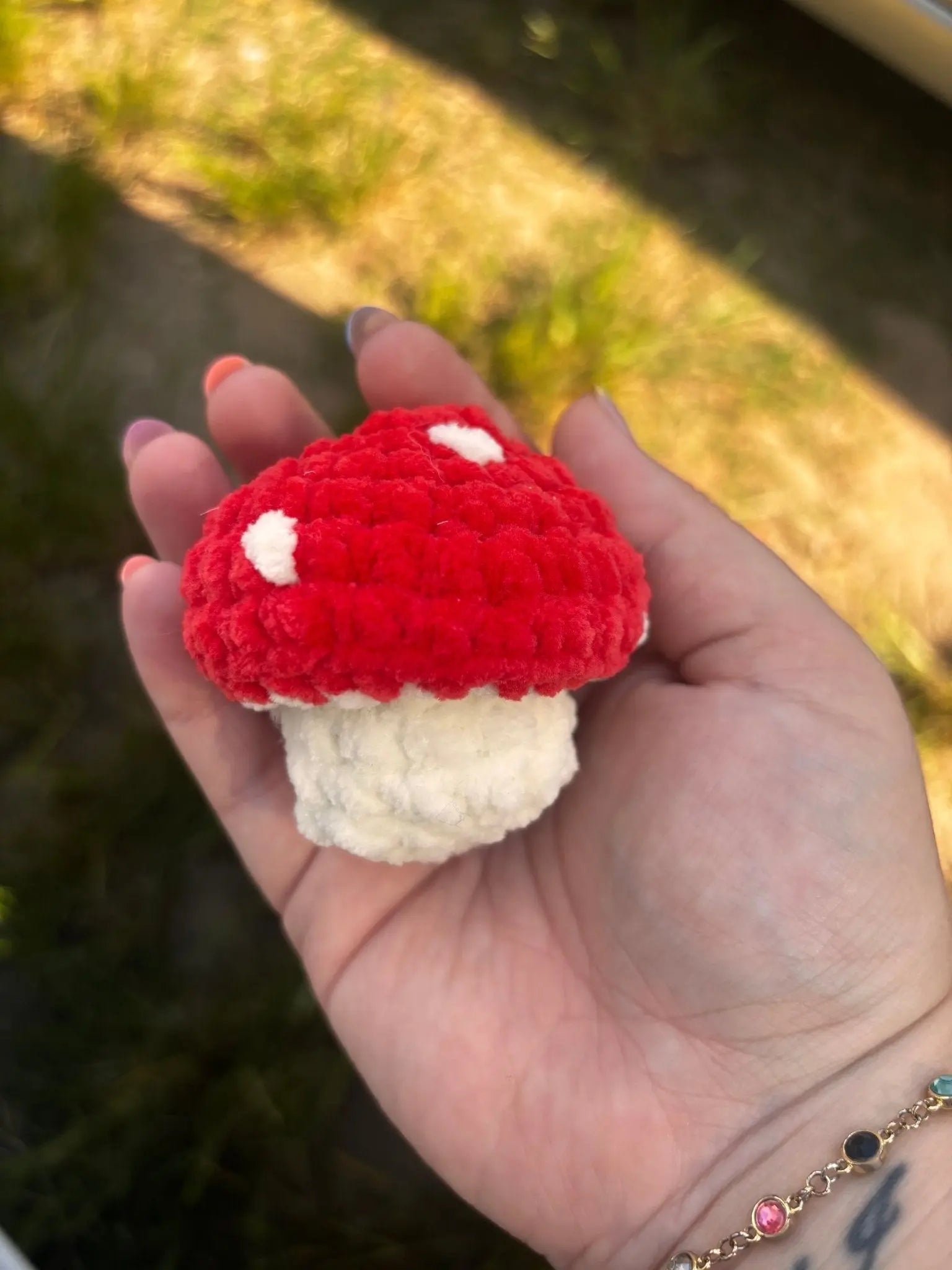 Crochet Mushroom Toy: Handmade Red Amigurumi Mushroom in Hand - Main Street Collective