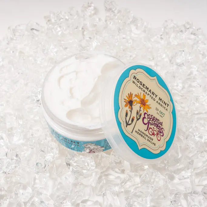 Rosemary Mint Arnica Salve in open jar on ice