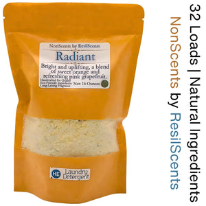 Orange bag of ResilScents Radiant laundry detergent with citrus scent, showing detergent granules through clear window. HE detergent label.