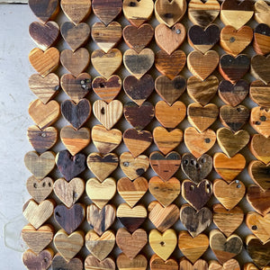 Collection of reclaimed pallet wood hearts with natural wood grain and variations.