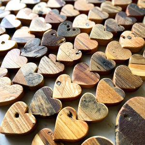 Assortment of reclaimed wood heart shapes with visible grain patterns.