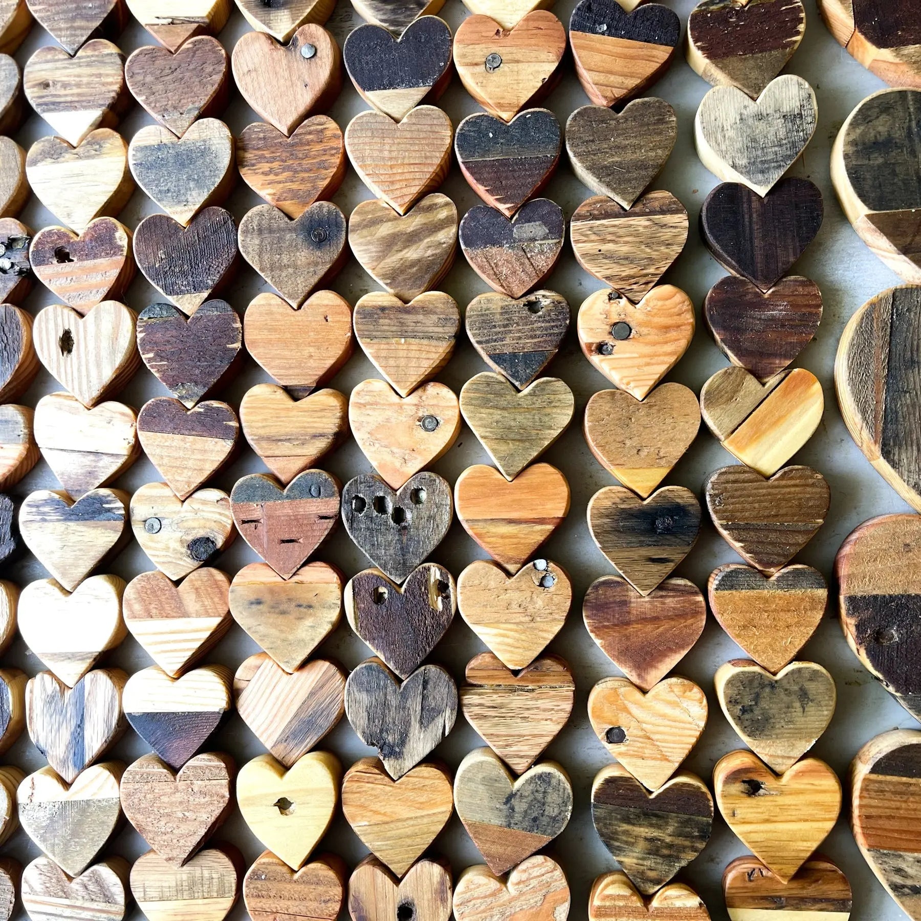 Assortment of rustic wooden hearts made from reclaimed pallet wood.