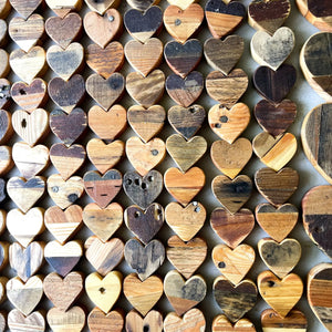 Assortment of rustic wooden hearts made from reclaimed pallet wood.