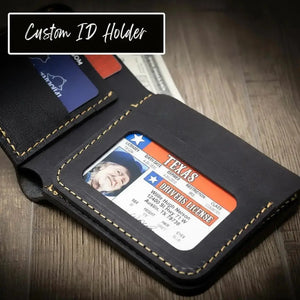 Black leather bifold wallet holding a Texas driver's license and cards.