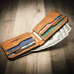 Handcrafted brown leather bifold wallet with cards and US dollar bills
