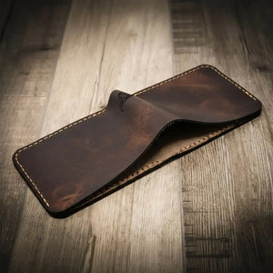 Brown leather bifold wallet with visible stitching