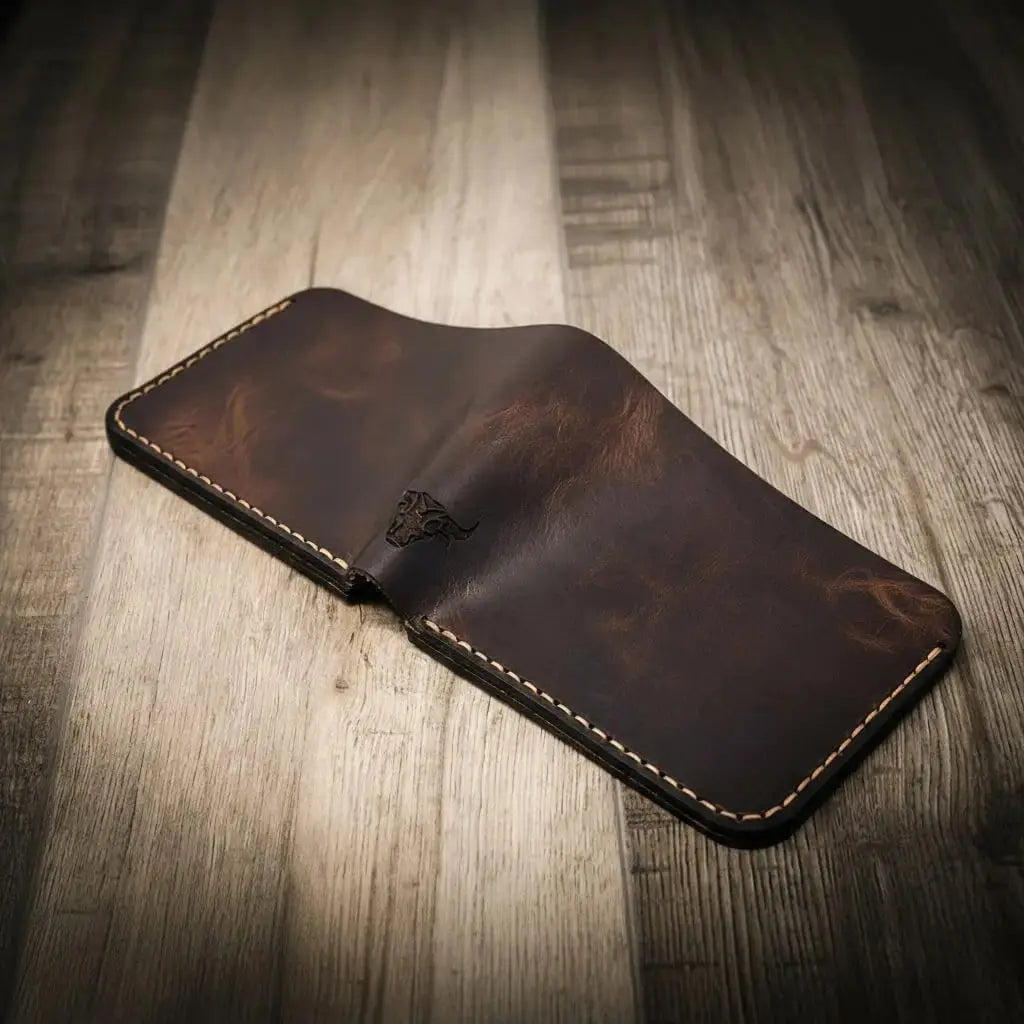 Brown leather bifold wallet with embossed bull emblem