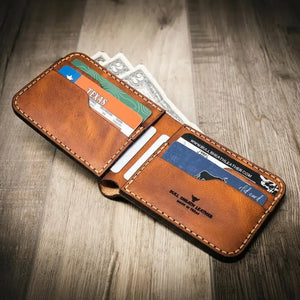 Brown leather bifold wallet with credit cards and cash on a wooden surface.
