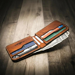 Brown leather bifold wallet with Texas card and money