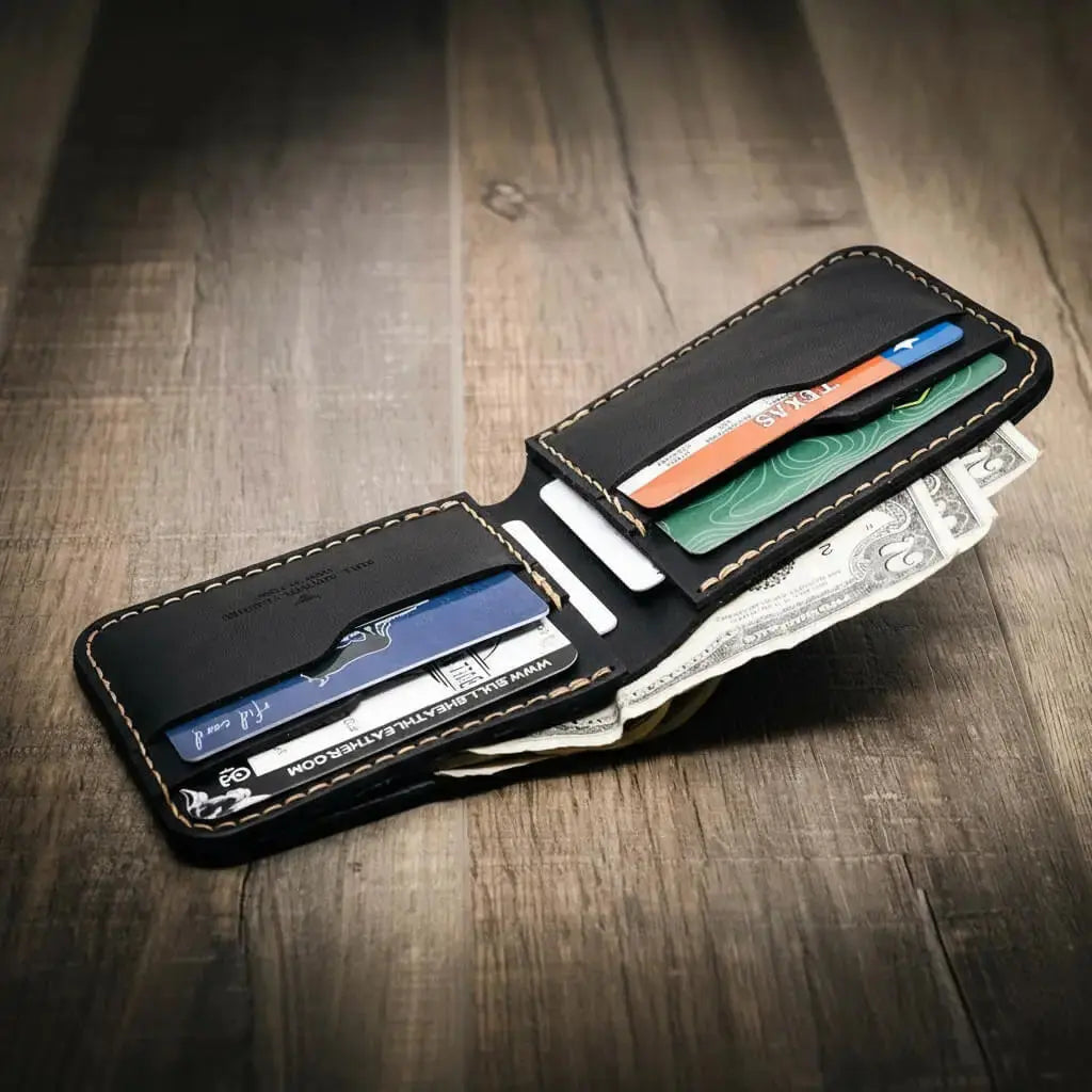 Black leather bifold wallet open with credit cards and US dollar bills visible